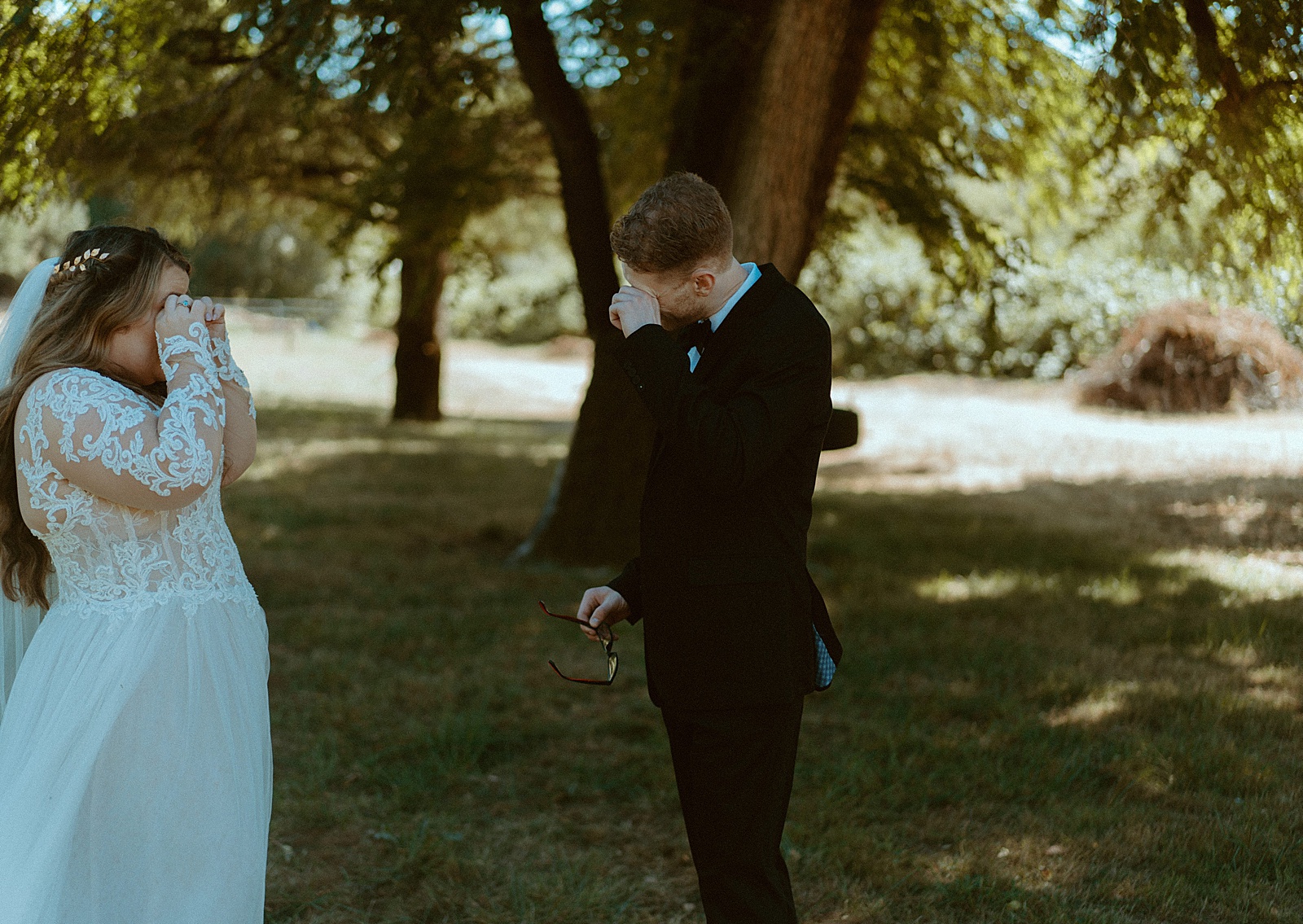 Bride and groom first look under trees by Danielle Johnson Photography
