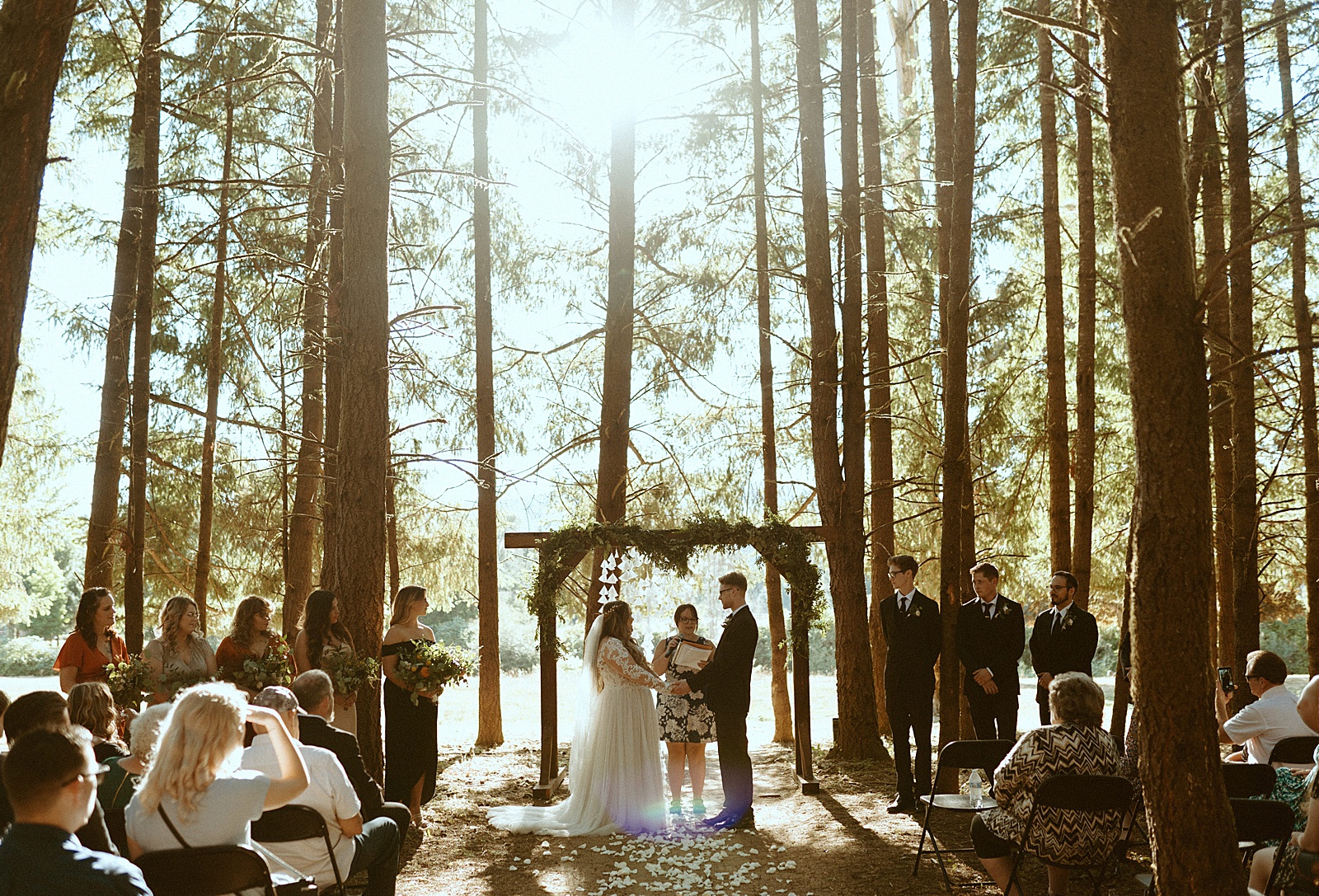 Bride and groom at alter in Oregon forest wedding by Danielle Johnson Photography