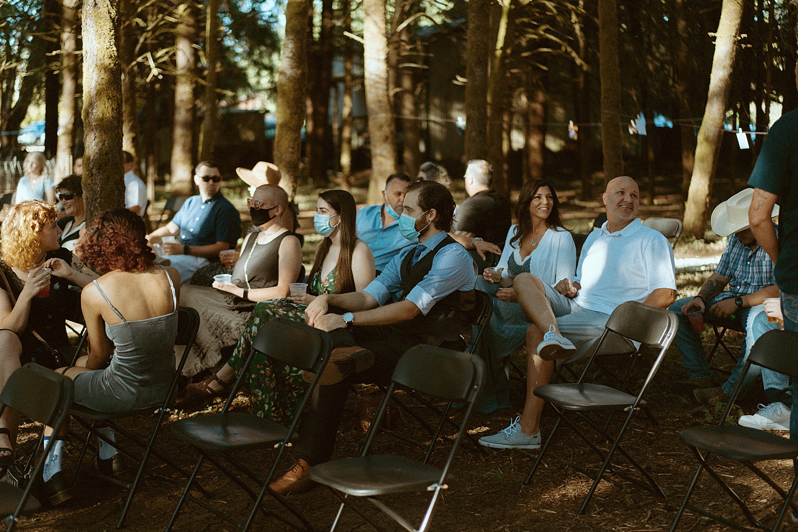 Guests watching Bride and groom at alter in Oregon forest wedding by Danielle Johnson Photography